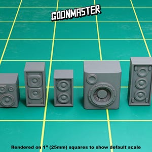 May include: Five gray speaker models, rendered on 1" (25mm) squares to show default scale. The speakers are all rectangular with rounded corners and have a single speaker cone on the front. The largest speaker is in the center and has a larger speaker cone than the other speakers.
