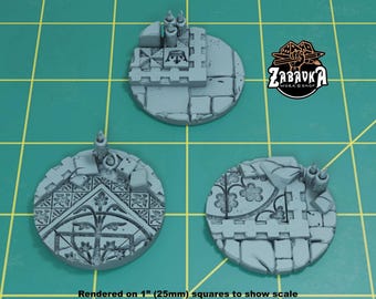 May include: Three gray miniature bases with detailed architectural designs, including arched windows, floral patterns, and candle holders. The bases are round and sit on a green grid. The text "ZABAVKA WORK SHOP" is visible.