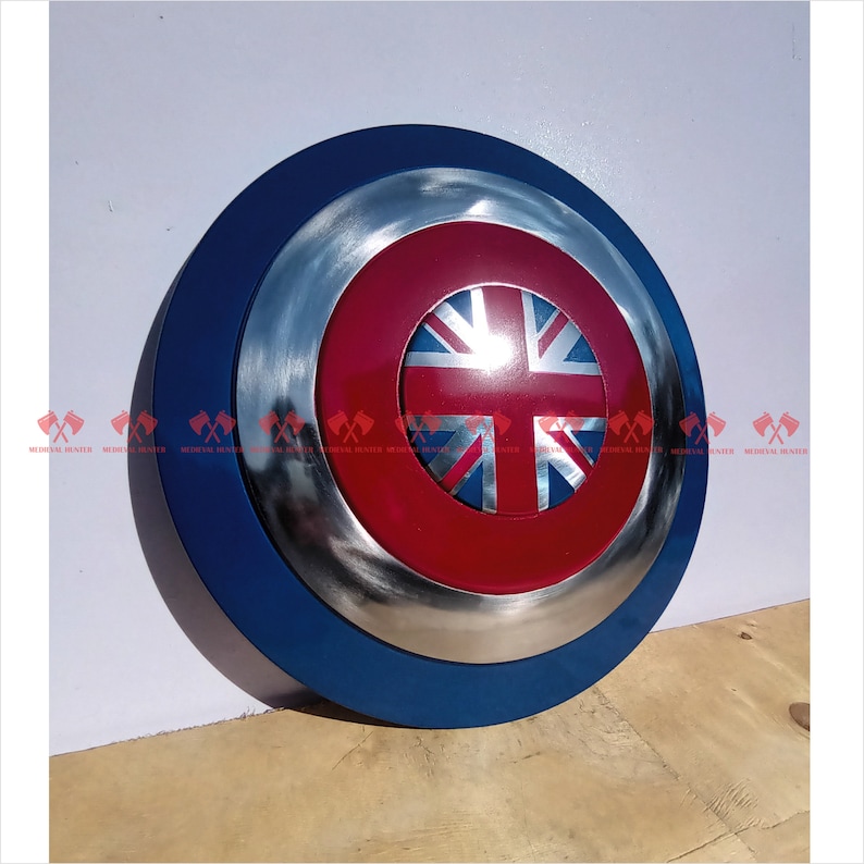 May include: A blue and silver shield with a red and blue Union Jack flag in the center.