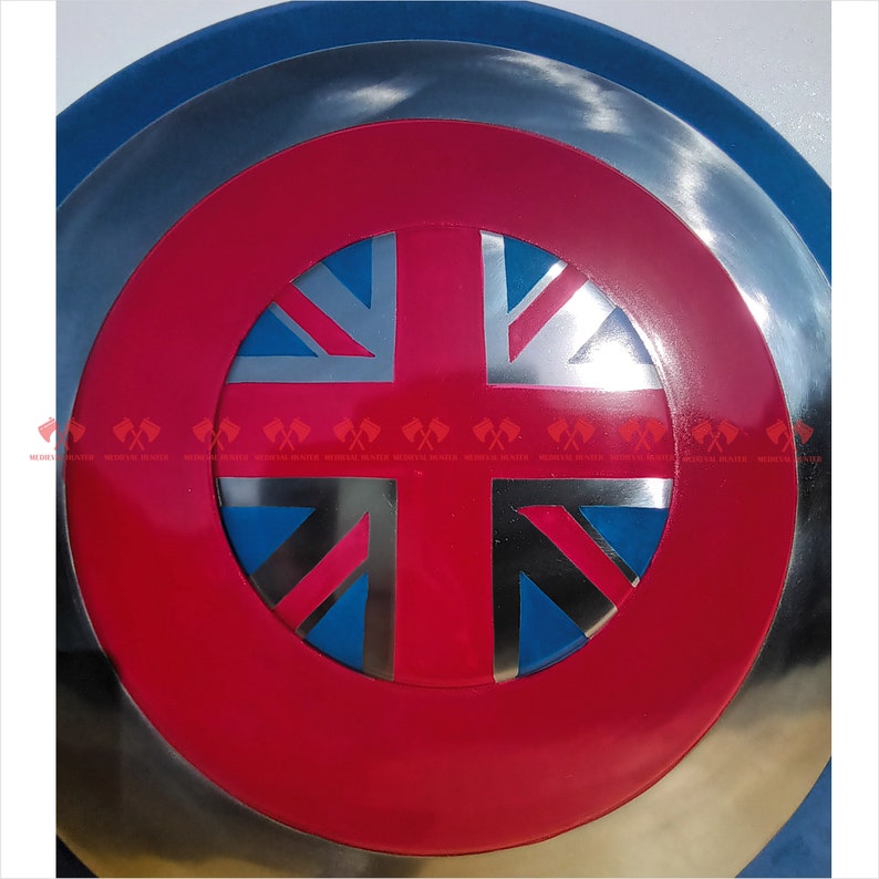 May include: A red, white, and blue Union Jack flag is displayed on a silver and blue circular shield. The shield has a raised rim.