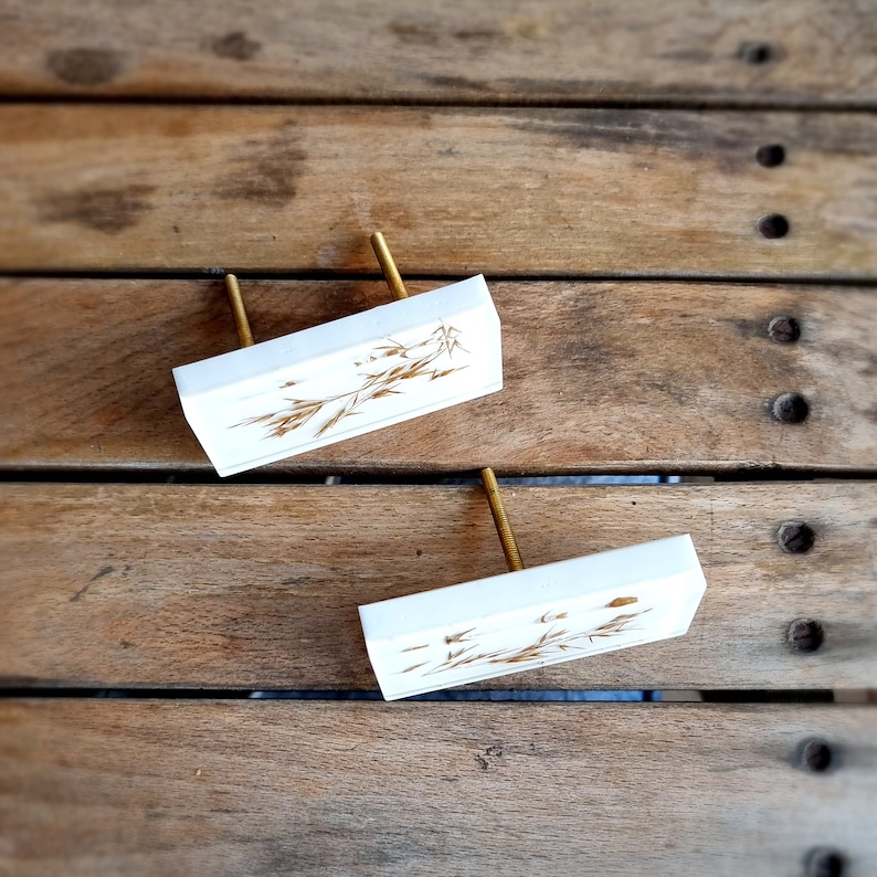 Add a charming touch to your cabinets and furniture with our handcrafted rustic green drawer knobs and oat drawer pulls. These unique pieces will enhance the look of any space, bringing a natural and organic feel to your home decor.