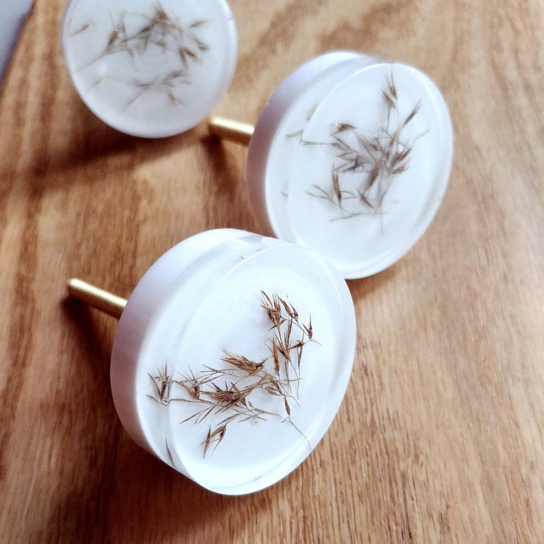 delicate white knobs with dried flowers, perfect handles for wooden furniture renovation, minimalistic and scandinavian home decor design 