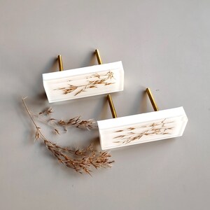 Add a charming touch to your cabinets and furniture with our handcrafted rustic green drawer knobs and oat drawer pulls. These unique pieces will enhance the look of any space, bringing a natural and organic feel to your home decor.