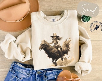 Sweater met cowgirl-berijdende kip: grappig cadeau voor landelijke folklore