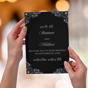 May include: Black save the date card with silver floral accents. The text reads "save the date, Shannon and Matthew, Welcome you to their wedding on September XX, 20XX, wedding town, wedding state."