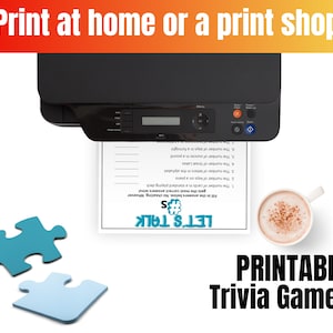 May include: A black printer outputting a white sheet of paper with a trivia game titled Let's Talk #s, featuring seven numbered questions. Two teal puzzle pieces are on the left, and a white mug with a brown beverage is on the right.