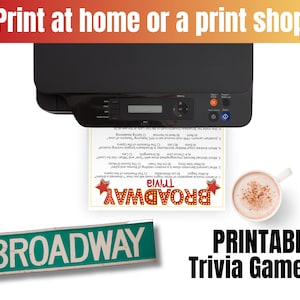 May include: A black printer printing a Broadway trivia game sheet. The sheet has trivia questions and the word "Broadway" in a red and yellow design. A cup of coffee sits next to the sheet. The image also includes a Broadway street sign.