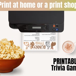 May include: A printer printing a "Bunny Trivia" game sheet. The image includes a bowl of popcorn, a cup of coffee, and the text "Printable Trivia Game."