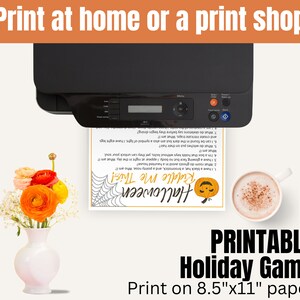 May include: Printable Halloween Riddle Me This game. The game is printed on a white sheet of paper with black text and a black and white illustration of a spider web. The text includes a list of riddles with a Halloween theme. The game is designed to be printed on 8.5 x 11 inch paper.