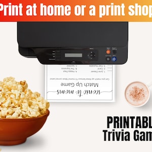 May include: Printable trivia game with the title "Iconic TV Moms" and a match-up game where you can match up famous TV moms. The game includes the names June Cleaver, Carol, and Clair Huxtable. The image also shows a printer, a bowl of popcorn, and a cup of coffee.