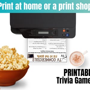 May include: A black printer printing a trivia game sheet with the text "TV Commercials Fill in the Blank". A bowl of popcorn and a cup of coffee are next to the printed sheet. The text "Print at home or a print shop" is at the top.