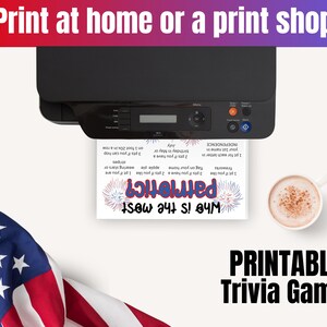 May include: A black printer outputting a white sheet of paper with a patriotic trivia game titled Who is the most patriotic? featuring red and blue text and firework graphics, alongside a white mug of coffee and a folded American flag.
