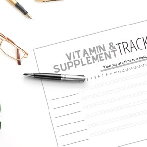 May include: A printable vitamin and supplement tracker with a gray background and white text. The tracker has a section for each day of the month and a space to mark off when you have taken your vitamins or supplements. The text at the top reads "Vitamin & Supplement Tracker" and "One day at a time to a healthier life."
