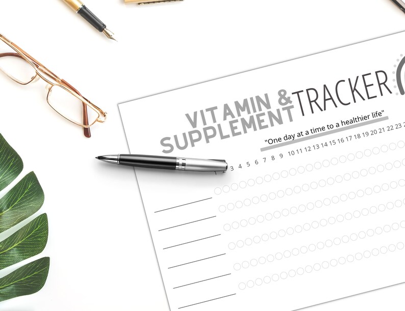 May include: A printable vitamin and supplement tracker with a gray background and white text. The tracker has a section for each day of the month and a space to mark off when you have taken your vitamins or supplements. The text at the top reads "Vitamin & Supplement Tracker" and "One day at a time to a healthier life."