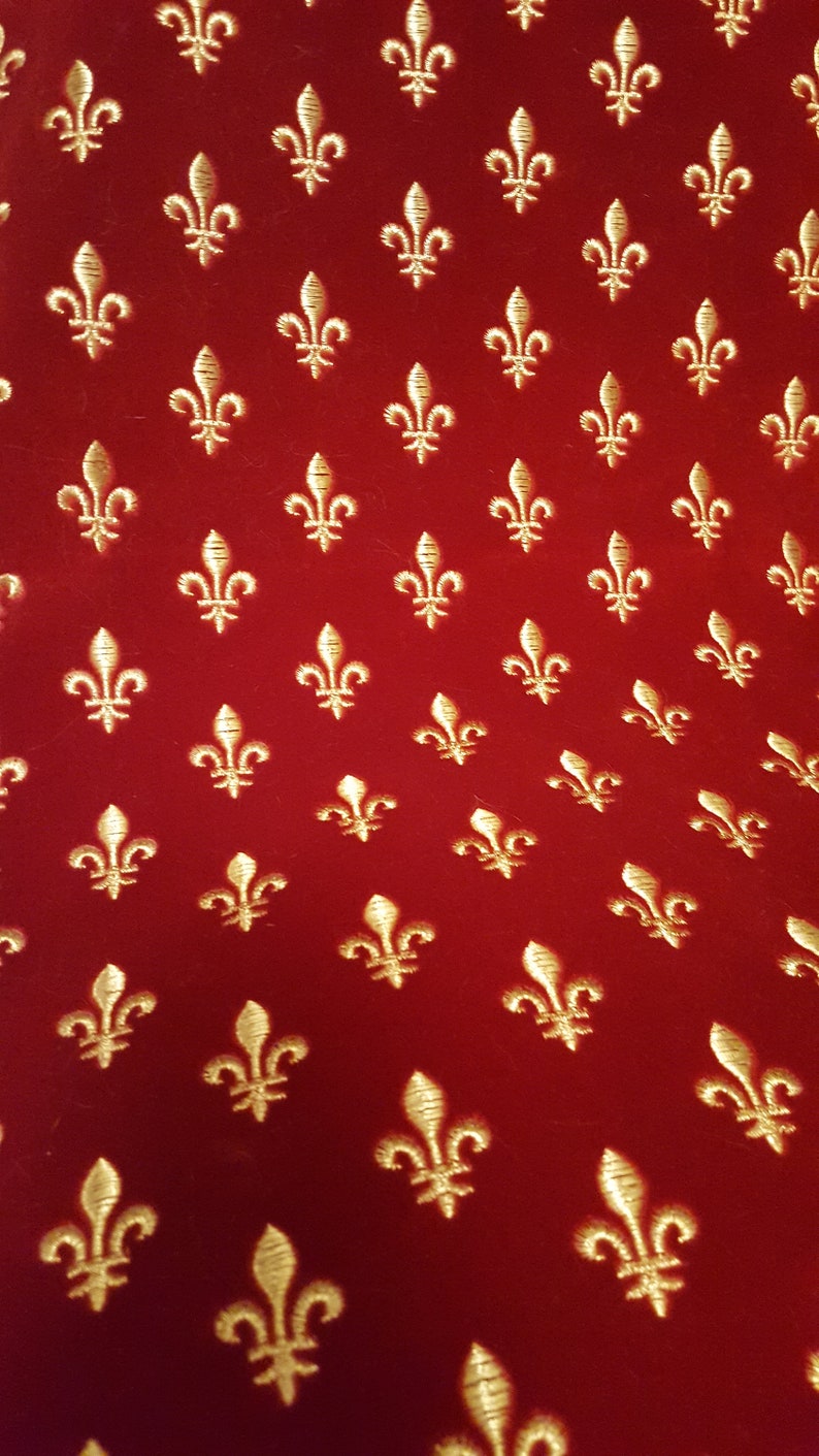 May include: Red fabric with a repeating pattern of gold fleurs-de-lis.