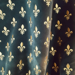 May include: A dark green fabric with a repeating pattern of gold fleurs-de-lis.