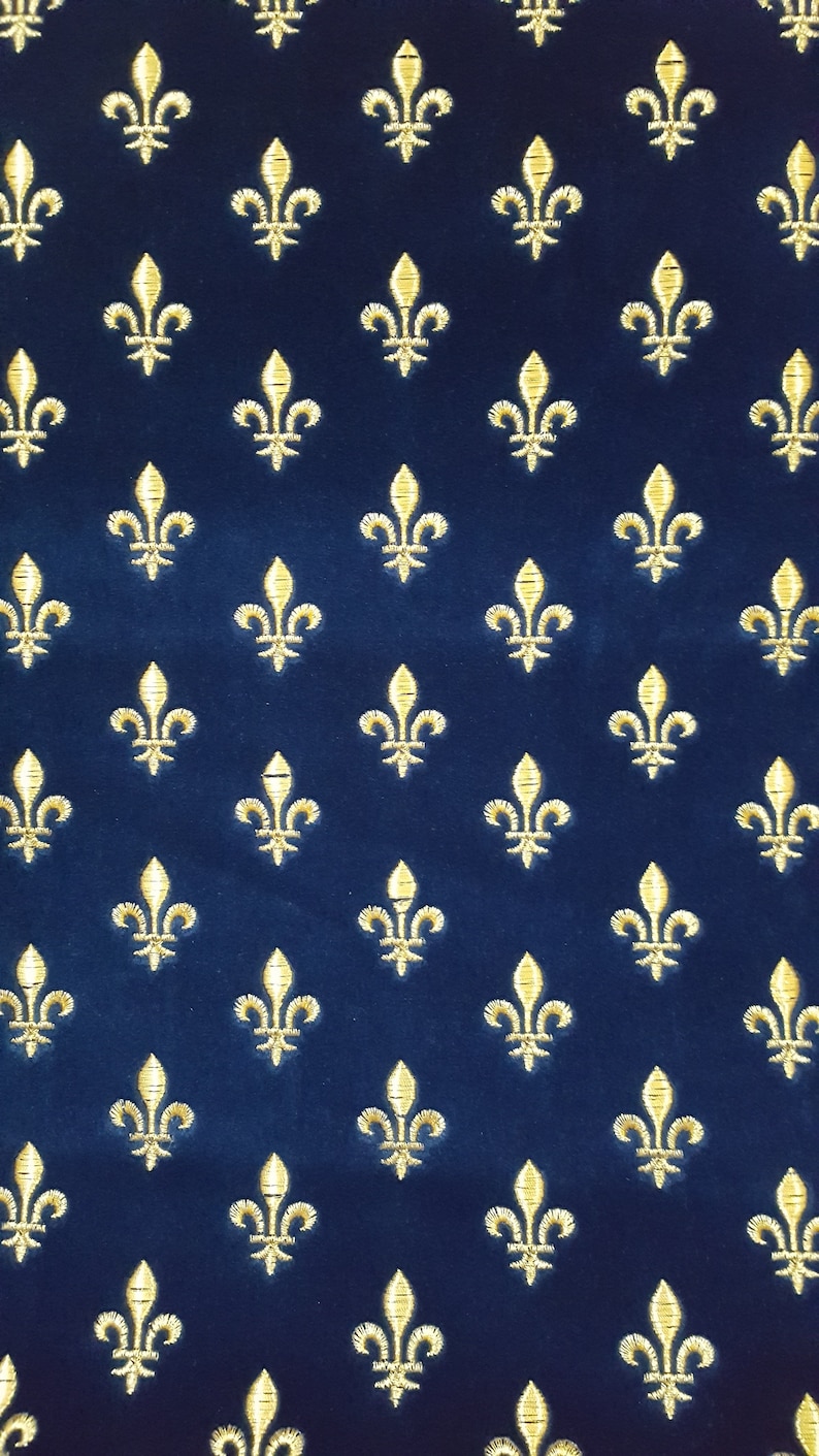 May include: A navy blue fabric with a repeating pattern of gold fleurs-de-lis.