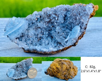 May include: A natural mineral specimen featuring a cluster of light blue crystals on a brown matrix. The specimen weighs 82 grams and measures approximately 2.6" x 1.4" x 1.8". The crystals have a delicate, layered appearance.