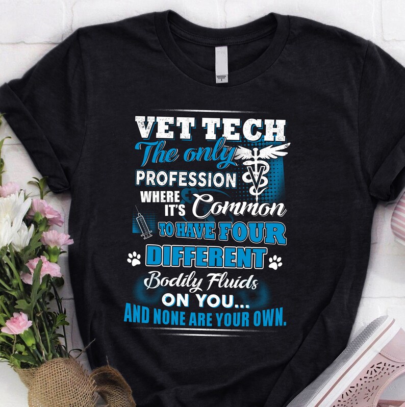 May include: A black t-shirt with a blue graphic that reads "Vet Tech The only profession where it's common to have four different bodily fluids on you... and none are your own."