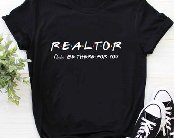 May include: Black t-shirt with the text "REALTOR I'LL BE THERE FOR YOU" in a white font with colorful dots.