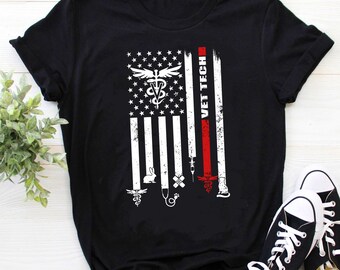 May include: Black t-shirt with a distressed American flag design featuring a veterinary symbol and the text "VET TECH".