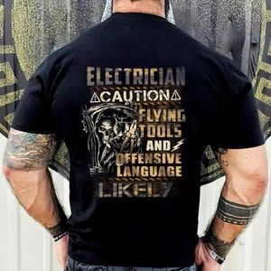 May include: Black t-shirt with a graphic of a grim reaper holding a wrench and the text "Electrician Caution Flying Tools and Offensive Language Likely".