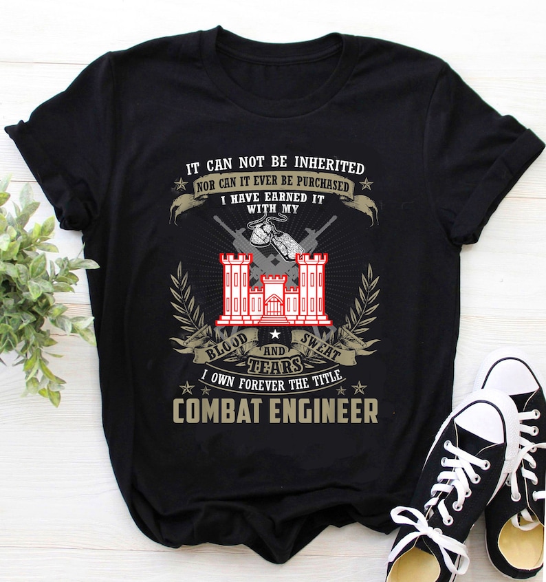 May include: Black t-shirt with a white graphic design featuring a military insignia, text that reads "IT CAN NOT BE INHERITED NOR CAN IT EVER BE PURCHASED I HAVE EARNED IT WITH MY BLOOD AND SWEAT TEARS I OWN FOREVER THE TITLE COMBAT ENGINEER", and stars.