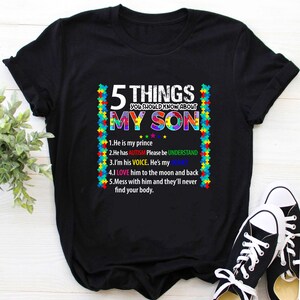 May include: Black t-shirt with a colorful puzzle piece border and the text "5 Things You Should Know About My Son". The text is followed by a list of five points about autism.