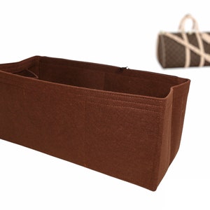 May include: Brown felt bag insert with multiple compartments. The insert is designed to fit inside a larger bag and help organise the contents.