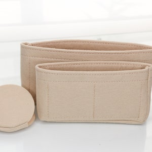 May include: Three beige felt bag organizers with different sizes and compartments. The largest organizer has three compartments, the medium organizer has two compartments, and the smallest organizer is round.