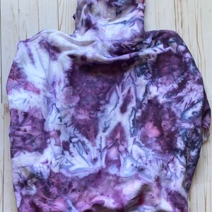May include: Purple, white, and gray tie-dye hoodie with a hood. The hoodie is made of a soft, comfortable fabric.
