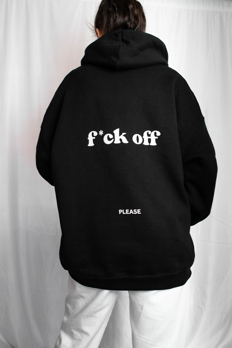 May include: Black hooded sweatshirt with the text "f*ck off" in white letters on the back. The text "PLEASE" is printed in white below the main text.