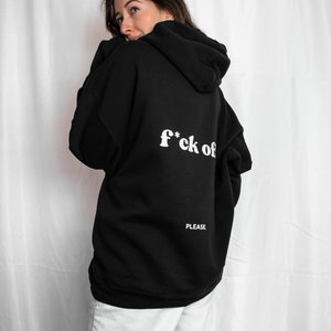 May include: Black hooded sweatshirt with the text "f*ck off" and "PLEASE" printed on the back.