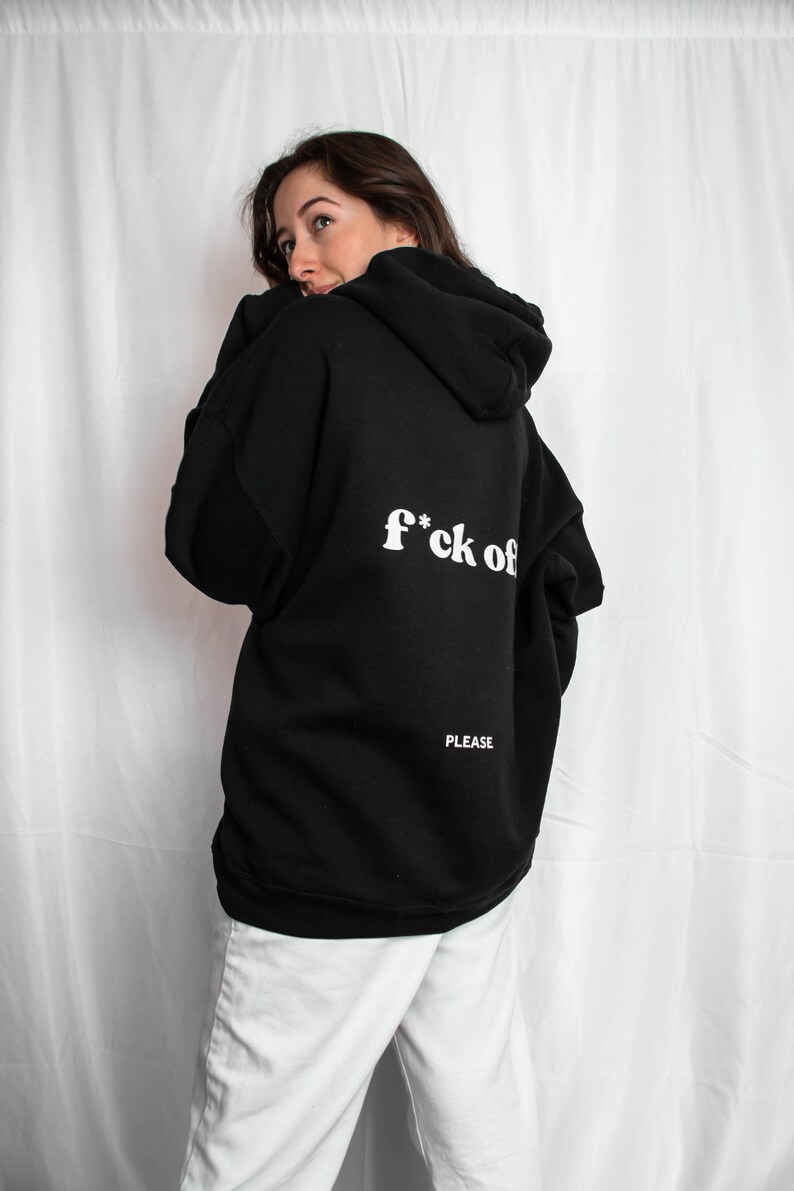 May include: Black hooded sweatshirt with the text "f*ck off" and "PLEASE" printed on the back.