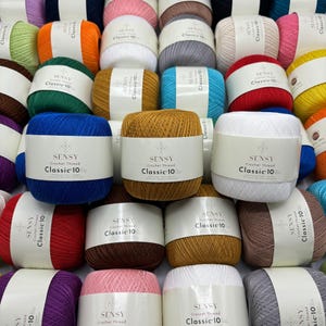 May include: A selection of colourful yarn balls with the text "SENSY Crochet Thread Classic-10" on the labels.