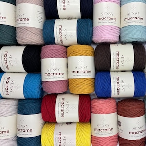 May include: A collection of colorful macrame cord spools in various shades, including teal, pink, yellow, and brown. Each spool is labeled with the brand "SENSY macrame" and the text "3 mm Twisted Macrame Cord."