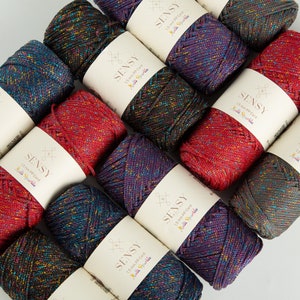 May include: A collection of 10 spools of 1.5 mm PP cord yarn in various colors with a glittery finish. Each spool has a label that reads "SENSY 1.5 mm PP Cord Multi Sparkle".