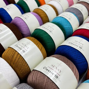 May include: A variety of colorful yarn balls with the label "SENSY Crochet Thread Classic 10" on each ball.