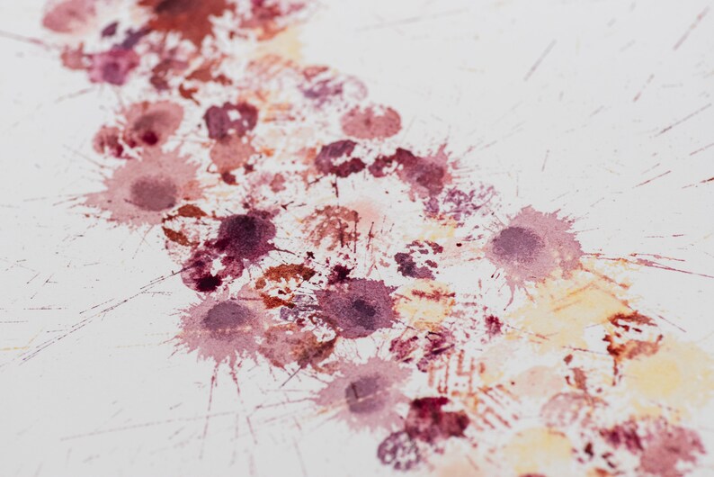 May include: A white background with a series of pink, red, and orange watercolor splatters. The splatters are arranged in a diagonal line from the top left corner to the bottom right corner of the image.