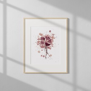 May include: A framed watercolor painting of a bouquet of pink and purple flowers with a splatter effect background.