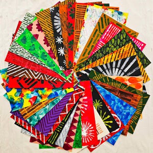 May include: A collection of colourful patterned paper cards, each with a different design. The cards are arranged in a circle, with the edges of the cards overlapping. The cards are all different colours and patterns, including red, green, blue, yellow, and black.