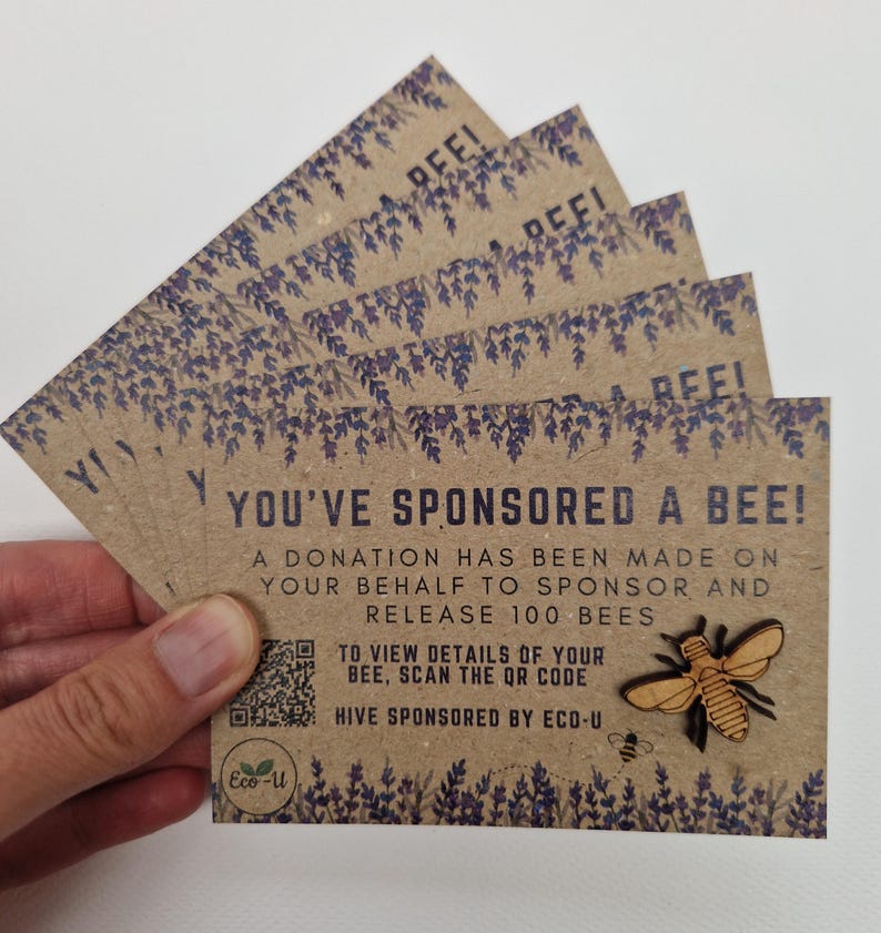 May include: A brown card with a bee illustration and the text "You've sponsored a bee!" A donation has been made on your behalf to sponsor and release 100 bees. To view details of your bee, scan the QR code. Hive sponsored by Eco-U.