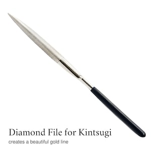 May include: A silver diamond file with a black handle.  Diamond File for Kintsugi creates a beautiful gold line.