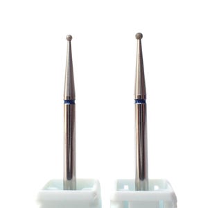May include: Two silver nail drill bits with blue bands and round diamond tips, mounted in white plastic holders.