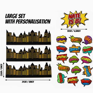 Puede incluir: Un conjunto grande de tres recortes de siluetas urbanas en negro y dorado de 21 cm por 7,5 cm, junto a varias burbujas de di&aacute;logo estilo c&oacute;mic con textos como WHAM, POW, OUCH, y un letrero personalizado NATE IS 8! de 12 cm.
