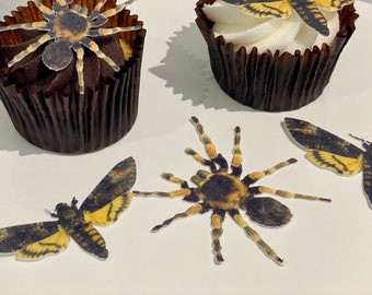 May include: Four edible cupcake toppers featuring realistic images of insects. Two are black and yellow tarantulas, and two are black and yellow moths.
