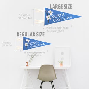 May include: Two blue pennant flags with the text "NORTH CAROLINA" and floral accents. The large flag is 12 inches (30.5cm) tall and 24 inches (61cm) wide. The regular size flag is 9 inches (23cm) tall and 18 inches (46cm) wide.