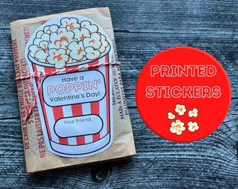 May include: A red and white popcorn bucket sticker with the text "Have a Poppin' Valentine's Day!" and "Your Friend."  The sticker is on a brown paper bag with the text "PRINTED STICKERS" on a red circle.