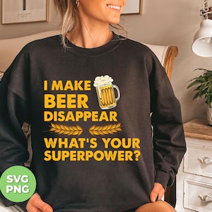 Puede incluir: Sudadera negra con un gráfico blanco que dice "Hago que la cerveza desaparezca. ¿Cuál es tu superpoder?" con una jarra de cerveza de dibujos animados.