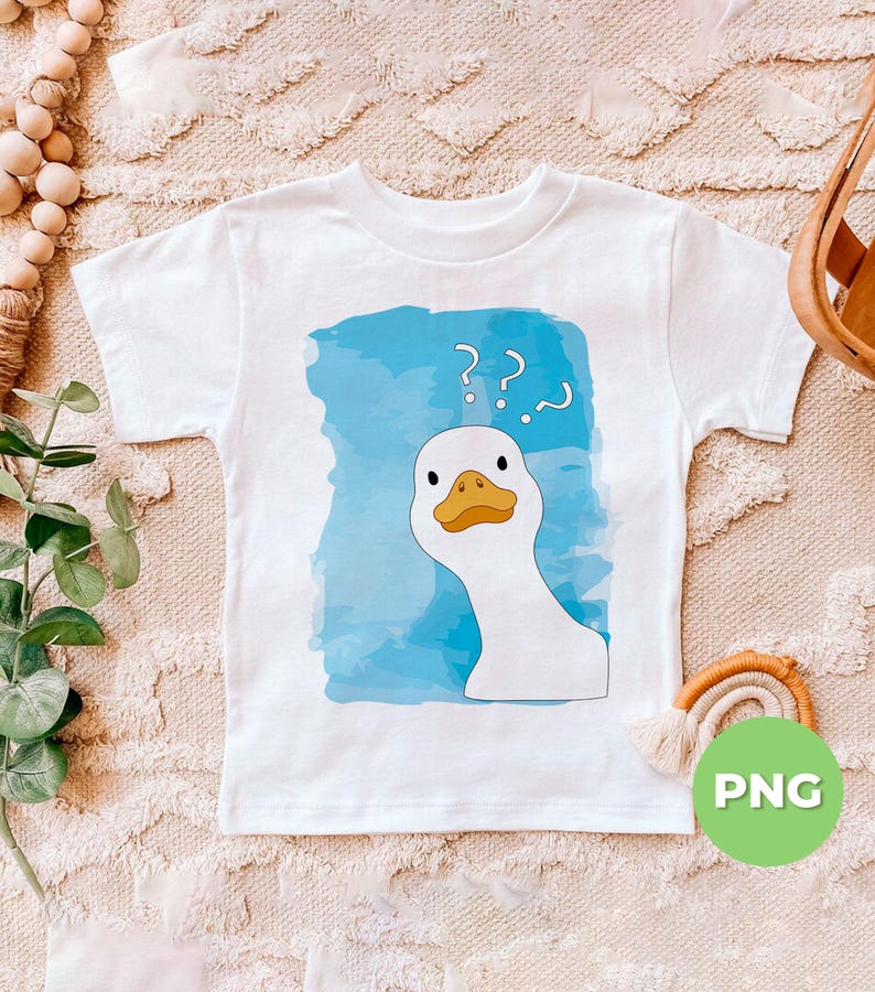 May include: A white t-shirt with a blue watercolor background and a cartoon white goose with a yellow beak and black eyes. The goose has question marks above its head. The t-shirt has the word 'PNG' in green text on a white circle in the lower right corner.